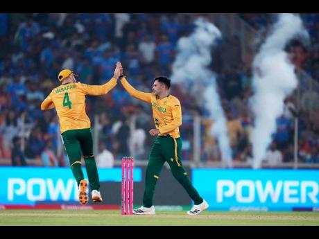 Credit: AP South Africa’s Keshav Maharaj (right) celebrates with captain Aiden Markram the wicket of India’s Arshdeep Singh during the T20 World Cup cricket match in Ahmedabad, India, on Sunday, Feb. 22, 2026.