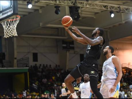 Credit: Ian Allen Kentan Facey from Jamaica takes a jump shot during their FIBA Americas Group Two World Cup Qualifier against The Bahamas at the National Indoor Sports Centre last night.