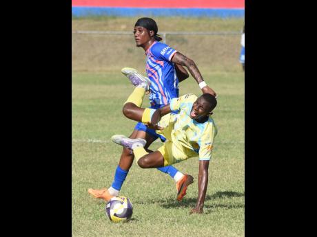 Jesus Gudino (front) of Waterhouse FC is fouled by Javier Brown of Portmore United during their Jamaica Premier League football match at the Ferdi Neita Sport Complex on Thursday. Waterhouse won 1-0.