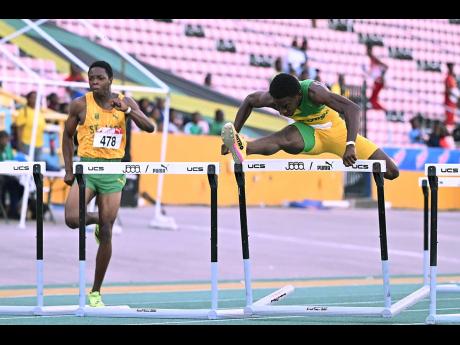 Romario Jibbison (right) and Marquies Page, both of St Jago High School competing in the Under-20 boys’ 110m hurdles finals. The duo powered to a 1-2 with Jibbison winning in 13.37 and Page second in 13.60.