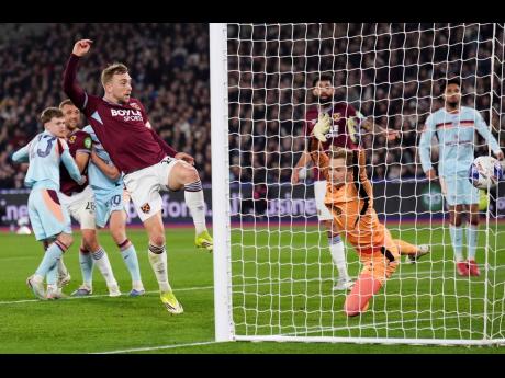 West Ham United’s Jarrod Bowen scores during the English FA Cup fifth-round soccer match against Brentford in London, England, on Monday.