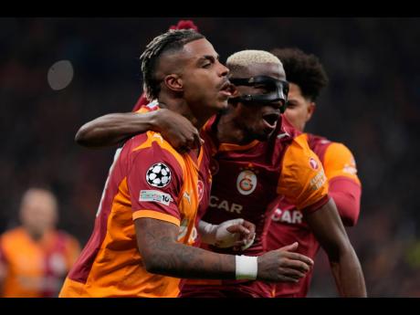 Galatasaray’s Mario Lemina (left) celebrates after scoring during a Champions League round-of-16 first-leg match between Galatasaray and Liverpool, in Istanbul, Turkey, yesterday.