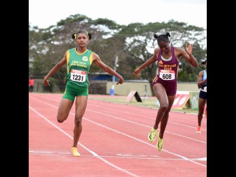 Ian Allen/Photographer 
Jesena Williams (left) of Vere Technical High School wins the Class One girls’ 200 meters final, in 24.38 seconds, ahead of Kristen Herbert (24.47) of Holmhood Technical at the ISSA Central Athletics Championships at GC Foster College of Physical Education and Sport on Wednesday, February 25.