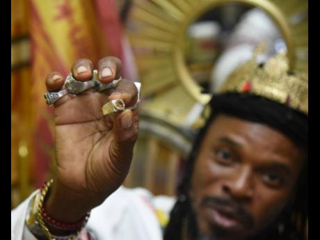 Credit: Ian Allen LA Lewis displays what he calls his powerful guard ring, which he says provides spiritual protection against negative forces.