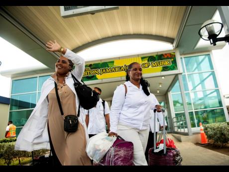 Credit: FILE Members of a contingent of Cuban medical professionals arrive at the Norman Manley International Airport in Kingston in 2020 to help Jamaica fight against COVID-19.