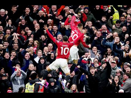 Manchester United’s Benjamin Sesko and Matheus Cunha celebrate after a goal during the English Premiier League soccer match against Aston Villa in Manchester, England, on Sunday.