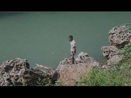 Divers preparing to search for a teenager whose vehicle plunged into the Rio  Cobre about 11:45 pm last night, it is believe that the teen was the driver, two other  teenagers were rescued