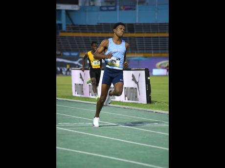 Credit: Ian Allen Romario Finnigan of Edwin Allen High wins his Class One 100 metres heat in a fast 10.18 seconds.