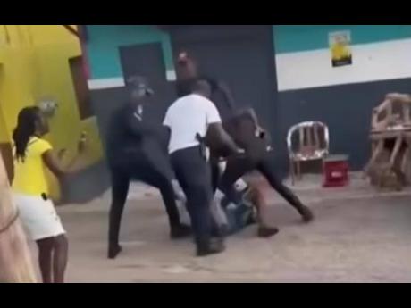 A screenshot from a video in which a man was seen being assaulted by cops in Trelawny.