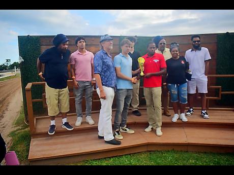 Connections of FUNCAANDUN react during the presentation ceremony, after their charge, ridden by Robert Halledeen, had won the Alexander Hamilton Memorial Trophy ahead of SUPER NATURAL POWER (Raddesh Roman) over seven furlongs at Caymanas Park on Saturday, March 14.