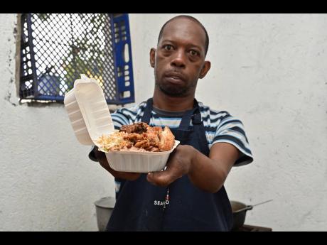 Powell boxes up a meal ready for a customer.