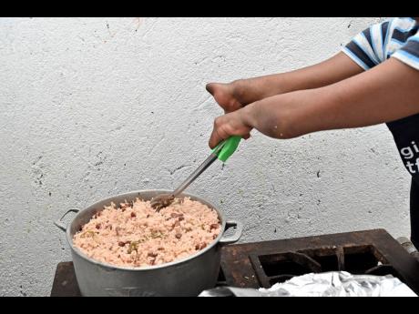 Powell makes sure that the rice and peas dish is good to go.