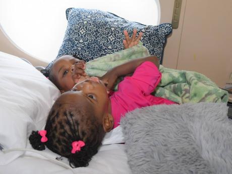 Conjoined twins Azora and Azaria Elson are pictured aboard a Medevac aircraft at Norman Manley International Airport, ahead of their departure to Saudi Arabia for life-changing separation surgery.