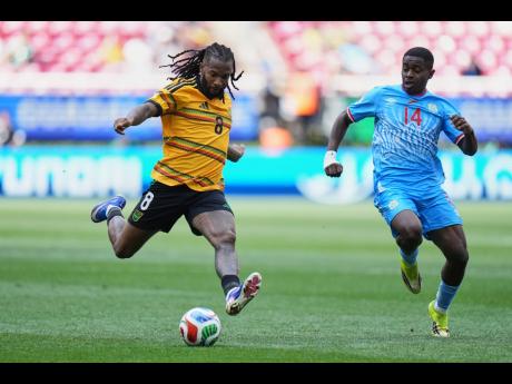 Jamaica’s Kasey Palmer (left) and DR Congo’s Noah Sadiki compete for the ball during the World Cup playoff final match between DR Congo and Jamaica in Guadalajara, Mexico, last night.