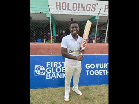 St Jago captain Vitel Lawes is all smiles after leading his side to the First Global Bank Grace Shield title in a game against Campion College at Melbourne Cricket Oval yesterday.