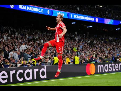 Bayern’s Harry Kane celebrates scoring his side’s second goal during the Champions League quarterfinal first-leg  match between Real Madrid and Bayern Munich in Madrid, Spain, yesterday.