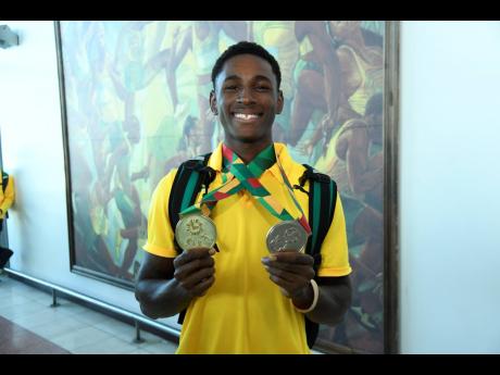 Sanjay Seymore, the Carifta Games Under-20 200 metres champion, displays his gold medal along with his silver medal from the 4x100m. 