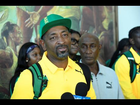David Riley, technical leader for the Carifta Games team, speaks to the media at the Norman Manley International Airport shortly after the team arrived home from Grenada. Looking on at second right is Jamaica Athletics Administrative Association President Garth Gayle.