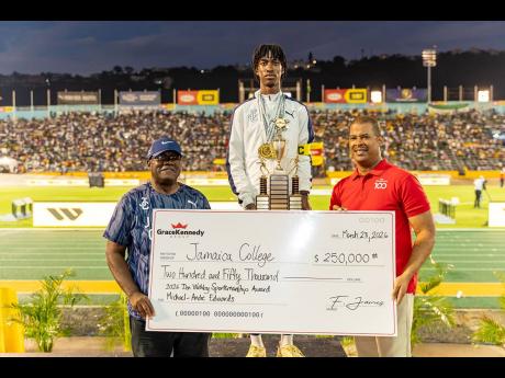 Michael-Andre Edwards (centre), vice-captain of the Jamaica College (JC) track team, is pictured with the 2026 Don Wehby Sportsmanship Award, as Frank James (right), GK Group CEO, presents the symbolic cheque for $250,000 to Wayne Robinson (left), principal of JC. The presentation took place during the final day of the ISSA/GraceKennedy Boys and Girls’ Athletics Championships, on March 28, at the National Stadium.