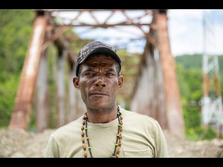 Credit: Gladstone Taylor Cephas Johnson revisits the bridge where he was pulled from the brink of death by rescuers.