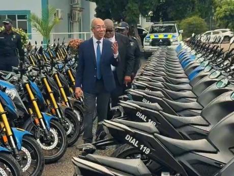 Minister of National Security and Peace, Dr Horace Chang, inspects some of the new motorcycles that have been added to enhance the mobility of the Jamaica Constabulary Force.