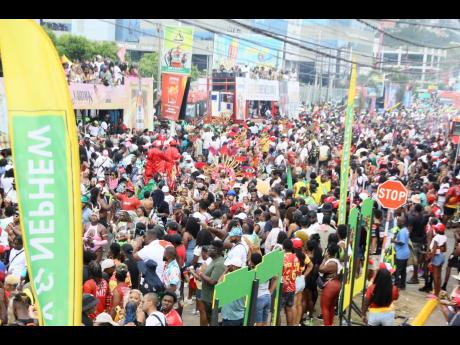 Members of Yard Mas make their way along Hope Road during yesterday’s road march.