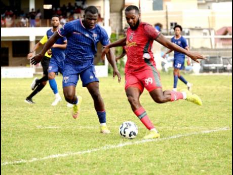 Montego Bay United’s Brian Brown (right) prepares to kick the ball as Spanish Town Police’s Shamar Harris (centre) reacts during their Jamaica Premier League football game at Jarrett Park in Montego Bay on Sunday. MoBay United won 6-0.