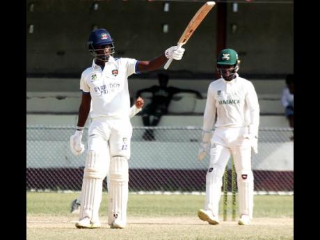 Credit: Lennox Aldred Barbados Pride’s Kevin Wickkham raises his bat after scoring 150 against Jamaica Scorpions on the opening day of their West Indies Championship cricket match against Jamaica at Chedwin Park in St Catherine on Sunday.