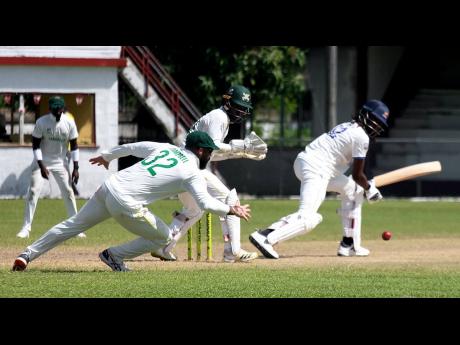 Credit: Lennox Aldred Barbados Pride's Shamar Springer gathers runs as Jamaica Scorpions captain John Campbell (slip) and wicket keeper Romaine Morris look on the opening day of their West Indies Championship cricket match against Jamaica at Chedwin Park in St Catherine on Sunday.
