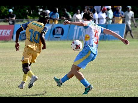Credit: Rudolph Brown Alexander Bicknell, (right) of Waterhouse controls the ball as Nickyle Ellis, of Racing United react during their Jamaica Premier League football match at Ferdi Neita Park on Sunday.