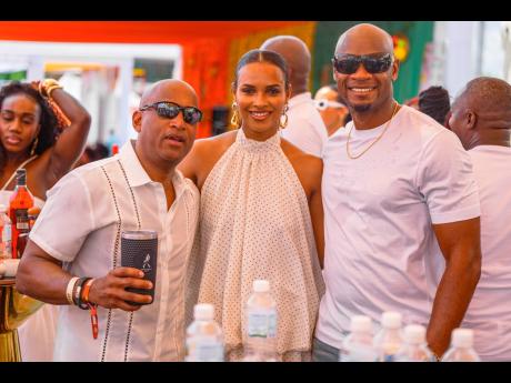 From left: Red Stripe Head of Commerce Sean Wallace, Alyshia Miller-Powell and her husband, sprint legend Asafa Powell, share a moment at Daybreak.