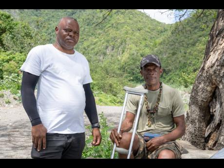 Gregory Williams (left) speaks with Cephas Johnson, who fell through a hole in the Easington Bridge on October 30 last year and miraculously survived.