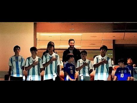 Argentina forward Lionel Messi (centre, top) watches from a box with family and friends at the start of an international friendly soccer match between Venezuela and Argentina on October 10, 2025, in Miami Gardens, Florida.