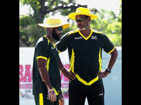 Jamaica Sorpions coach Robert Haynes (right) chats with captain John Campbell during the West Indies Championship cricket match against Barbados Pride at Chedwin Park on Wednesday.