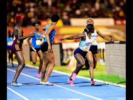 Edwin Allen (right) making the final baton exchange on the 4x400m open girls relay final ahead of Hydel High (centre) and Holmwood Technical at the ISSA GraceKennedy Boys and Girls’ Athletics Championships at the National Stadium in St Andrew, Jamaica, on Saturday, April 1, 2023. The three are among Jamaican institutions expected to contend for top honours at the upcoming Penn Relays.