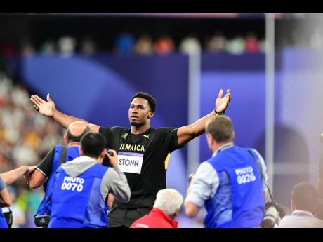 Jamaica’s Roje Stona celebrates an Olympic record-breaking gold-medal performance in the men’s discus at the Stade de France in Paris, France, on Wednesday, August 7, 2024.