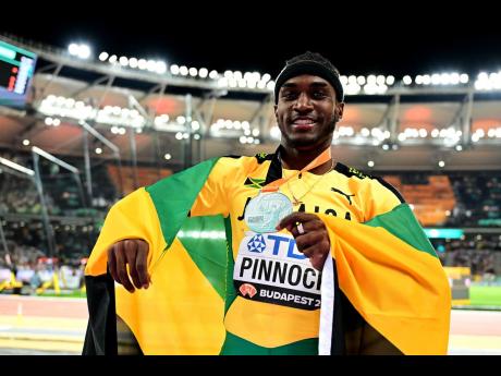 Wayne Pinnock of Jamaica celebrates a silver medal in the men’s long jump final during the evening session of the 2023 World Athletics Championships at the National Athletics Centre in Budapest, Hungary, on Thursday, August 24, 2023. 