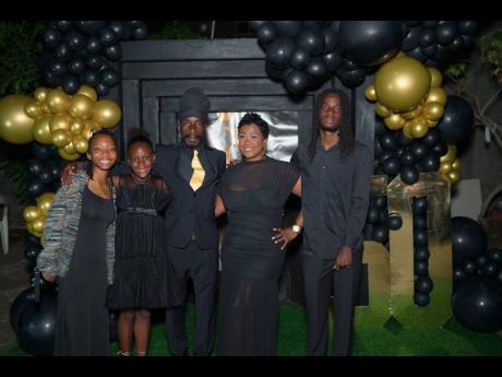 Sizzla is surrounded by his family at his 50th birthday celebration (from left) daughters Zahdié Collins, and Malkia Collins; wife Anika Collins and son Mekai Collins.