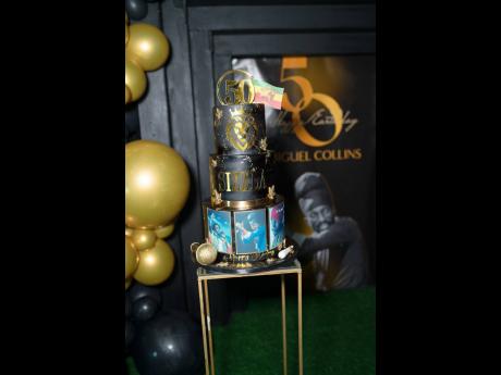 The three-tier cake features photos of SIzzla. 