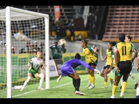 Reggae Girlz captain Khadija Shaw (right), looks on as her header goes toward Guyana’s Rylee Traicoff during their Concacaf W Qualifer inside the National Stadium on Saturday night. Jamaica won 2-0 with Shaw scoring the opening goal.