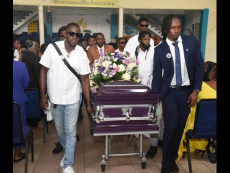 With measured steps, pallbearers escort the coffin bearing the remains of Kevaughn Goldson from King’s Chapel Seventh-day Adventist Church, Windward Road, Kingston, yesterday.