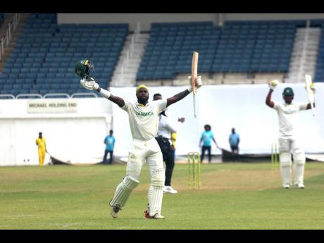 Jamaica Scorpions batsman Kirk McKenzie celebrates his century against the Barbados Pride at Sabina Park yesterday.