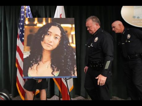 LAPD Chief Jim McDonnell walks past an image of Celeste Rivas Hernandez Monday, April 20, 2026, in Los Angeles after a press conference regarding the case of singer D4vd, who was charged on suspicion of killing the 14-year-old girl whose dismembered body was found in his car. (AP Photo/Damian Dovarganes)