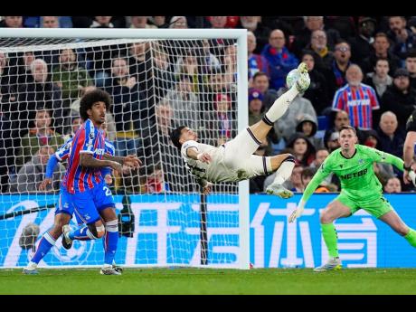 West Ham United’s Taty Castellanos tries an overhead kick during the English Premier League soccer match against Crystal Palace in London, England, on Monday.