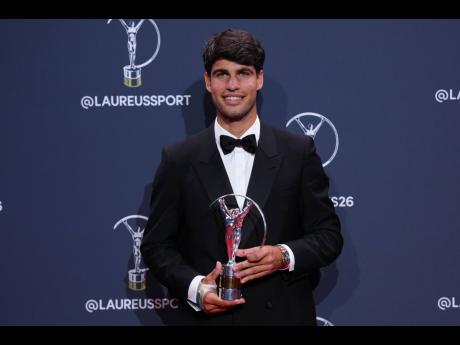 Carlos Alcaraz poses with his Laureus World Sportsman of the Year award.