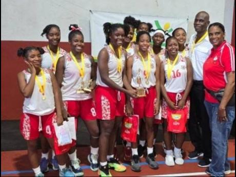 ISSA urban area schoolgirls basketball MVP Danae Brown (fourth from left) celebrates winning the title with teammates, Queen’s past student Olive McNaughton (right) and coach Donald Bimmer (second right), after they defeated St Andrew High 49-33 in the ISSA urban area final at UWI Bowl on Monday.