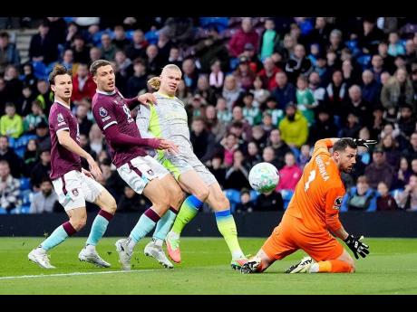 Manchester City’s Erling Haaland (second right) scores his side’s opening goal during the English Premier League soccer match against Burnley in Burnley, England, on Wednesday.