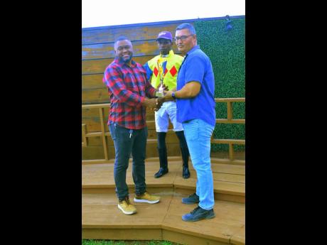 Winning jockey Tevin Foster (centre) poses with connections after guiding MABROUK to victory in the Sprint Trophy over five furlongs straight at Caymanas Park on Sunday.