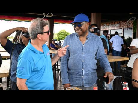 Tourism Minister Edmund Bartlett (right) engages with Jack Sprat Restaurant owner and hotelier, Jason Henzell, during a visit to the Lovers’ Leap attraction in St Elizabeth last Friday, as part of the second day of the South Coast Confidence Tour.
