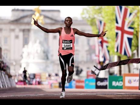 Sebastian Sawe from Kenya crosses the finish line to win the men’s race at the London Marathon in London on Sunday.